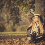 Girl with vintage camera in park