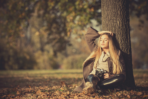 Girl with vintage camera in park